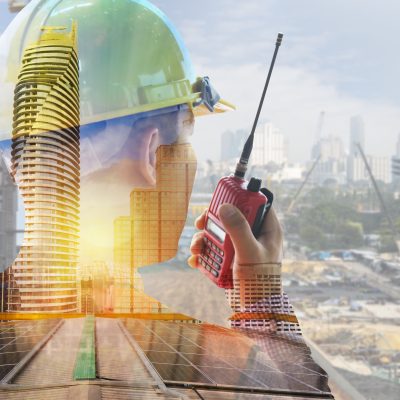 Engineer with safety helmet on solar energy background. Business about Natural energy concept. Double exposure, solar panels renewable energy and ecology